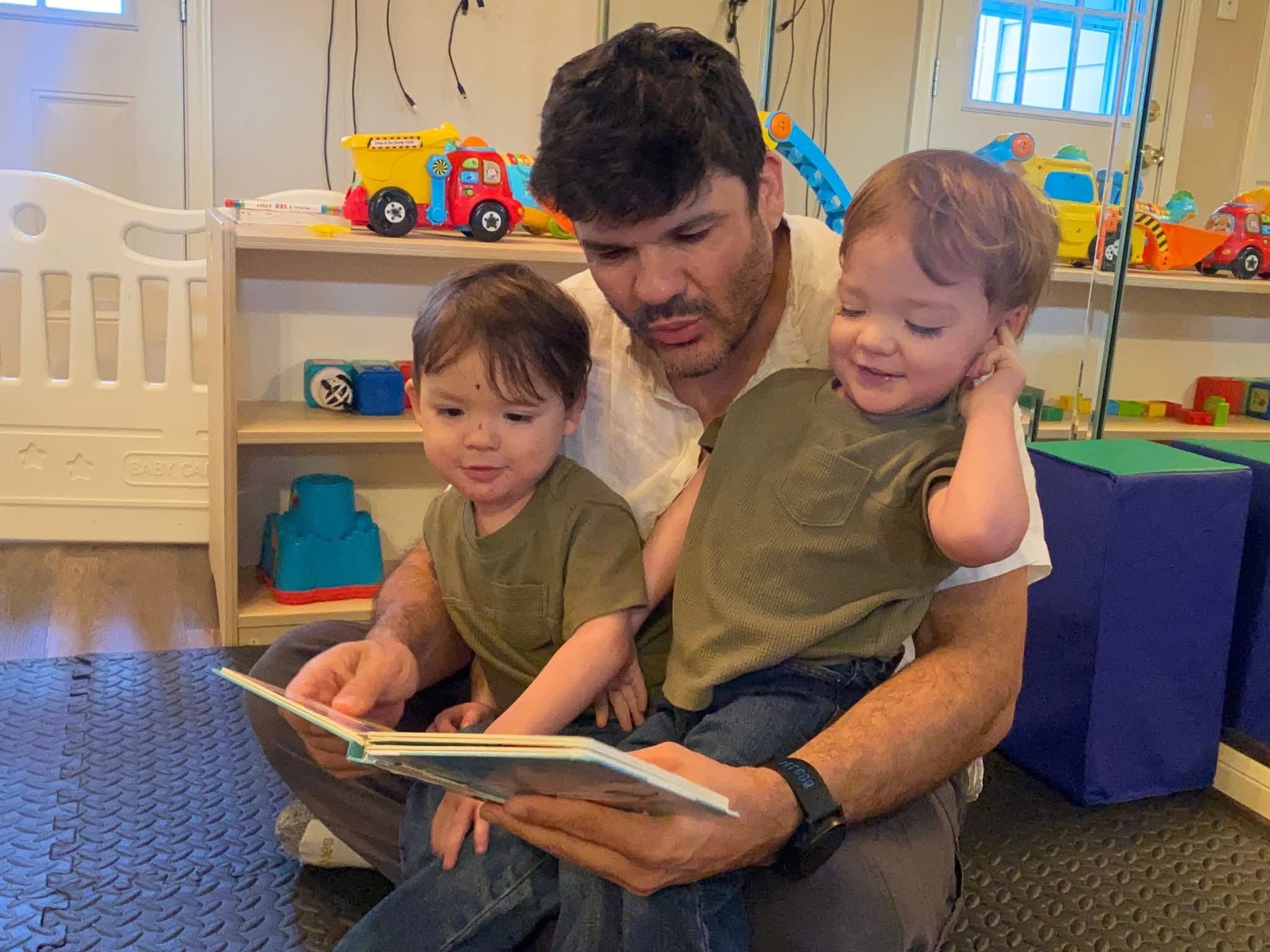 Adan reading with his children